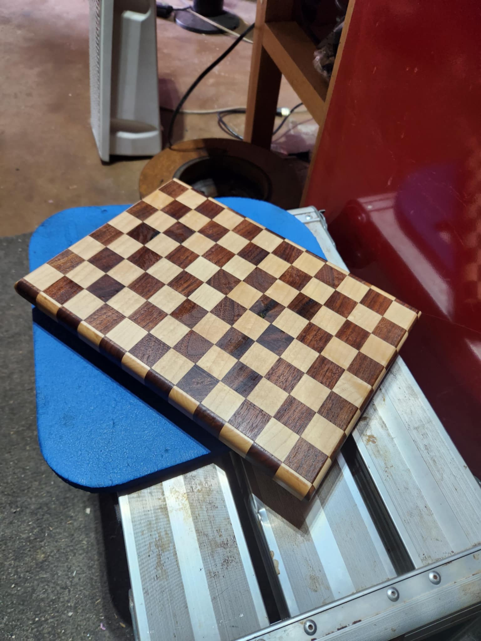 Chessboard-style cutting board with alternating wood squares